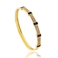 Detailed macro shot of gold plated bracelet with rectangular blue zircons and pavé settings - Blue