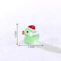 Miniature Christmas duck ornament in transparent green resin with red hat for DIY decor - Luminous Green
