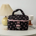 Quilted black makeup bag with pink bow patterns and pearl zipper pull details - Large / Black Pink