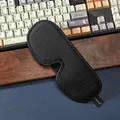 Close-up of 3D breathable sleep mask with ergonomic nose wing on a textured surface - Single Item / Black