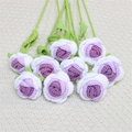 Handmade crochet roses in purple and white with green stems on a cream background - Gradient Purple