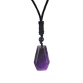 Detailed macro shot of a hexagonal purple amethyst pendant with a black woven cord - Purple Crystal