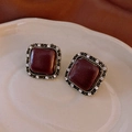 Macro shot of vintage square stud earrings with dark red resin and crystal inlay - Burgundy Style / Gold - Wine Red