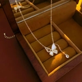 Detail of butterfly necklace with mother of pearl wing and sparkling zircon tassel - Gold Shell Wing Butterfly Necklace