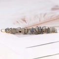 Macro view of grey natural stone hair clip with elegant gold-tone metal base detail - Labradorite + Gold Clip