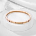 Detail of rose gold titanium bracelet with pink zircon stones and screw patterns - 4mm / Rose Gold-Pink Zirconia