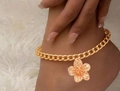 Elegant gold chain anklet featuring a textured flower pendant on model's ankle - Gold Flower Anklet (4830)