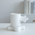 White ceramic star-handle mug with matching star saucer set in minimalist home setting - Star Cup & Saucer - White