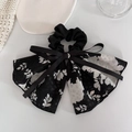 Detail of elegant black floral bow scrunchie with streamers in light silk fabric - 4# Black Bow Scrunchie