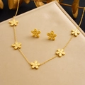 Elegant gold flower necklace and earring set displayed on a textured beige jewelry box - Gold 2-Piece Set (Necklace + Earrings)