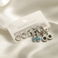 Three-piece stainless steel earring set with evil eye and Roman numeral charms - Roman Numerals Evil Eye Set