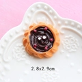 Macro shot of 2.8x2.9cm resin miniature dessert tart with chocolate swirl for DIY crafts - Red Bean Paste Bread