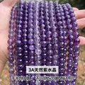 Hand holding strands of 3A natural amethyst beads for DIY jewelry making - 4mm approx 90pcs / 3A Natural Amethyst