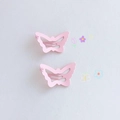 Close-up of two pink butterfly hair clips with a matte finish on a clean background - Matte Butterfly / Pink