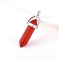 Hexagonal bullet-shaped red crystal stone pendant with silver metal buckle on white background - Natural Red Agate