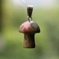 Unakite natural stone mushroom pendant with metal clasp in a scenic green background - Unakite