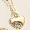 Macro shot of gold heart pendant necklace featuring vibrant rainbow zircon stones detail - Rainbow Zirconia Heart (XL2638-3)