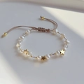 Detail of adjustable woven bracelet with natural freshwater pearls and gold star charm - Star Style (ZZS220012C)