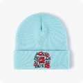 Detail of red lips embroidery and text on light blue knitted beanie hat - Lake Blue