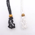 Detail of handmade woven net pouch necklace in black and white with wooden bead closure - Black Net + White Net