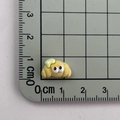 Mini resin croissant charm with cartoon eyes shown on a scale for size measurement - 11*Croissant Mini