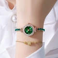 Macro view of women's gold-tone watch with green dial and gemstone-set link bracelet - Green