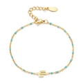 Detail of bohemian gold chain bracelet featuring blue beads and cactus charm pendant - Lake Blue