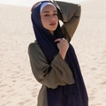 Solid color pearl chiffon long scarf hijab in deep blue worn by model in desert setting - Navy Blue