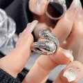Luxury silver serpent ring with shimmering pavé zircon and vibrant green gemstone eyes - Silver Double Head Cross Snake Green Eye