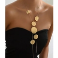 Minimalist long geometric necklace with gold discs worn by a model on a black top - Gold Round Disc