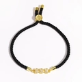 Macro detail of adjustable black braided rope bracelet with gold cubic zirconia charms - Triple Horizontal Rectangles (Style 25)