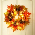 Artificial maple leaf wreath with pumpkins, pine cones, and warm LED lights on a white door - Pumpkin Pine Cone Wreath-45cm(With Light)
