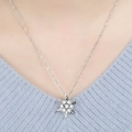 Silver snowflake pendant necklace with cubic zirconia on a blue knit sweater - Silver (6790)