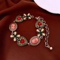 Macro shot of vintage gold bracelet with red heart gem and pink cameo on brown silk - Vintage Portrait Heart Bracelet (Gold-Green)