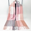 Pink and grey plaid thick cashmere-like scarf with tassels hanging on a hanger - Pink & White Plaid