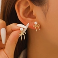 Elegant gold bow earrings with white pearls shown on model for a sweet stylish look - Gold Bow Pearl Stud Earrings (7046) / Gold/White / Stud Earrings