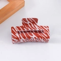 Large red and white zebra print hair claw clip made of durable plastic material - Red and White Zebra Print