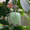 Detail of a green crystal stone pendant in a silver stainless steel mesh net necklace - Aventurine Jade