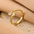Elegant gold open ring featuring two pear-cut cubic zirconia stones on a neutral stone background - Gold Dual Pear Zirconia Ring (A-804)