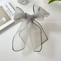 Grey organza bow hair clip with black stitched edges on a minimalist background - Grey Green