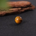 Polished 16mm yellow tiger eye crystal sphere showing natural chatoyant golden bands - Tiger's Eye