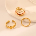 Detailed set of three gold-plated rings with enamel accents and sunburst textures on a tray - J581-Vintage Enamel Gold 3-Piece Set