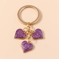 Golden keychain with three purple glitter heart pendants and a round metal ring - Large Heart / Purple