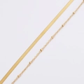 Detail of layered gold snake chain and beaded satellite chain in stainless steel - 18K Gold Plated