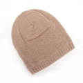Detail of light brown knit beanie showing textured geometric leaf patterns and ribbed edge - Khaki