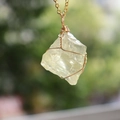 Macro detail of natural yellow crystal pendant with golden wire wrap craftsmanship - With Chain / Gold