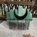Detailed view of natural green stones and black moon charm on a metal bridal hair comb - Green Aventurine Black Moon