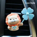 Detail view of a cute little lion vent clip on a black car air conditioner outlet - Orange Lion