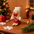 Christmas skiing doll ornament with red heart knit sweater and wooden skis on tabletop - Red Clothes & White Hat Skiing Girl Style C