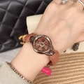Women's watch with brown flower dial and leather strap, worn by a model in lifestyle setting - Brown